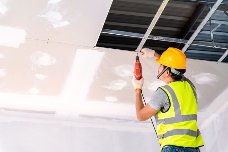 Construction workers using an electric drill are install the cei